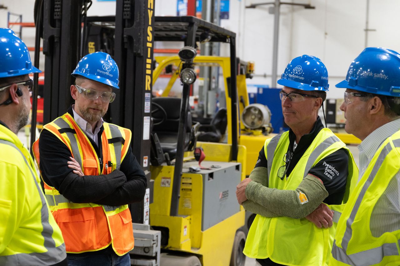 Group of employees standing discussing strategy